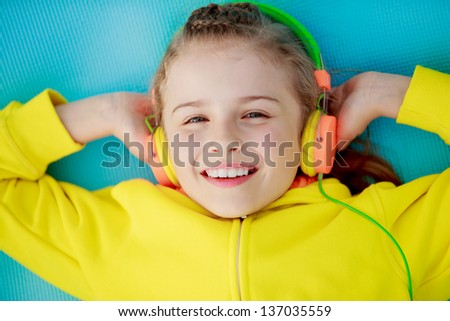 Young girl with headphones listening music, happy young girl. Lifestyle of young people concept.