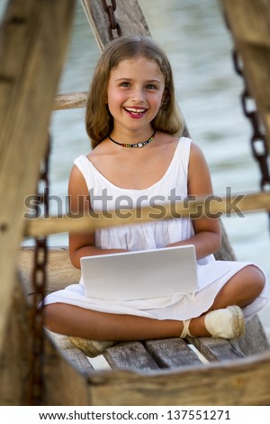 Girl with netbook - Lovely girl with netbook resting on the beach