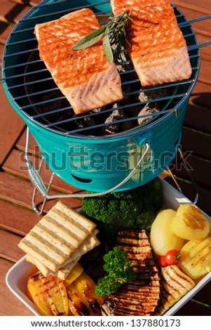Grilled salmon and grilled vegetables, grilling in the garden.