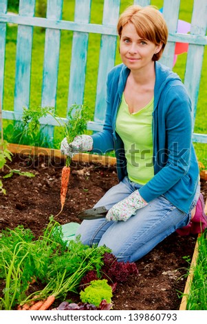 Beautiful woman and organically grown carrots