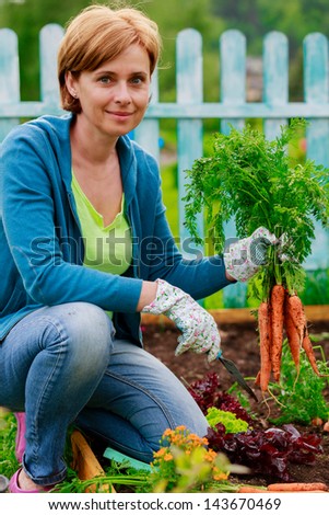 Garden, vegetables - woman and organically grown carrots