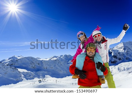 Ski, skier, sun and winter fun - family skiers  enjoying winter holidays