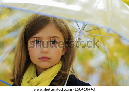 Autumn rain - beautiful girl with an umbrella in autumn park
