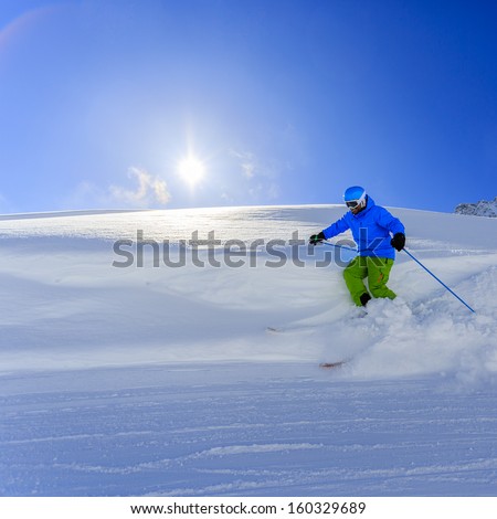 Skiing, Skier, Freeride in fresh powder snow - man skiing downhill