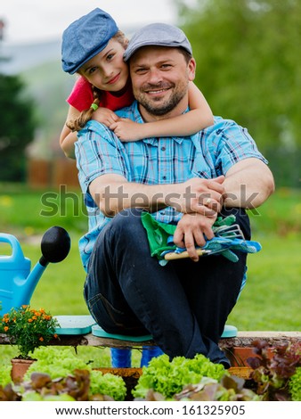 Gardening, planting, cultivation - lovely girl helping father in vegetable garden