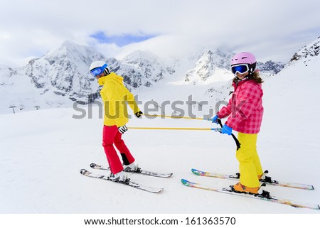 Skiing, skiers on ski run - winter fun, child on ski lesson