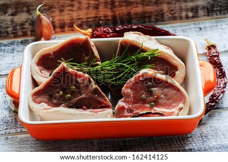 Lamb meat - fresh lamb chops with rosemary herbs
