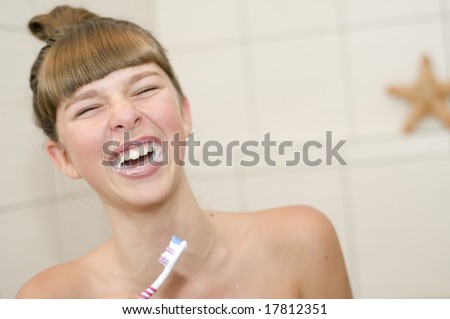 Girl brushing teeth in bath