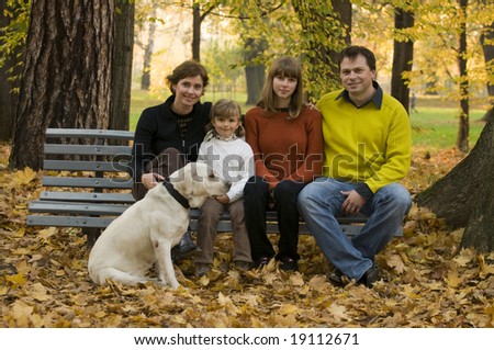 Happy family with dog at autumn time
