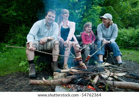 Happy family near campfire