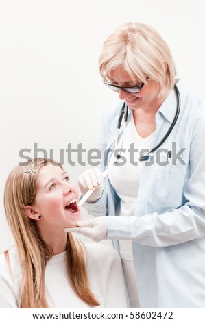 Doctor treat young girl for throat