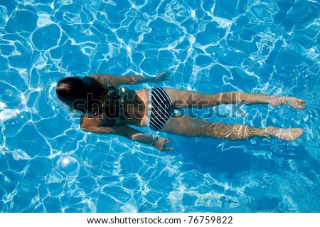 Summer vacation - beautiful girl diving in blue water