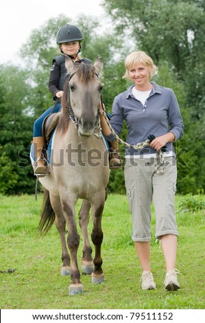 Horse riding - little girl is  riding a horse