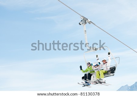 Winter - ski vacation - family on ski lift - space for text
