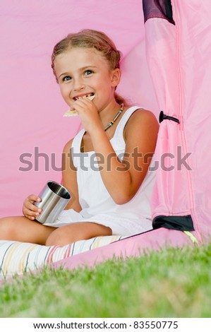 Camping in tent -  happy girl on camp tent