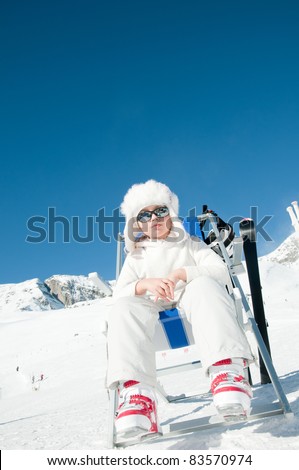 Happy winter vacation - little skier in ski resort (copy space, cover )