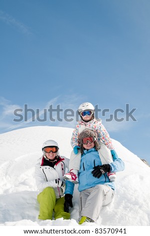 Winter, ski, sun and fun - happy family in winter resort (space for text, cover )