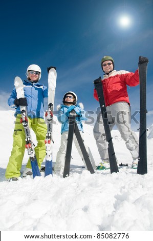 Winter, ski sun and fun - family in ski resort (copy space, cover)