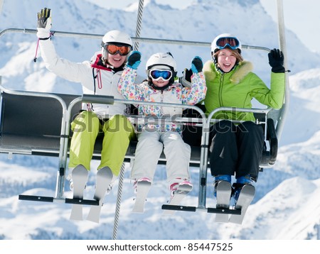 Ski lift - happy skiers on ski vacation