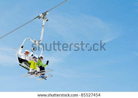 Ski lift - happy skiers on ski vacation (copy space)