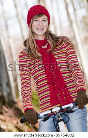Autumn biking - beautiful girl on bike