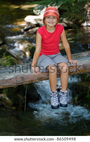 Mountain tip - little trekker resting on the mountain river