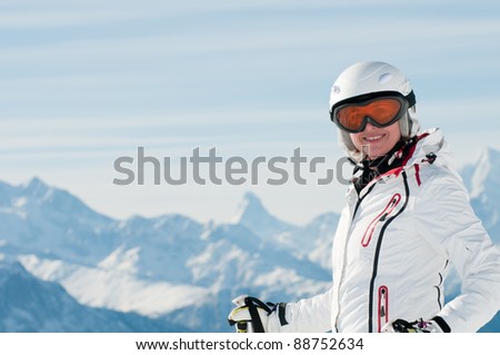 Ski vacation - female skier on ski slope in Swiss Alps