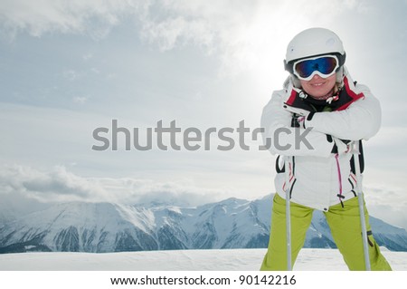 Skiing, portrait of female skier on ski slope - space for text