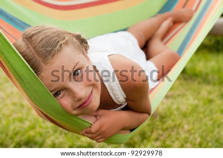 Happy childhood - Cute girl in colorful hammock
