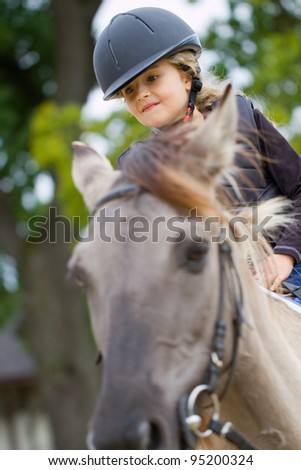 Horseback riding - lovely girl is riding a horse