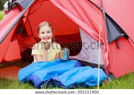 Summer Camp in the tent - young girl on the camping