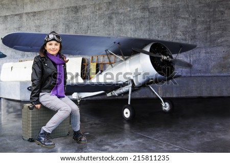 Aviator, happy girl ready to travel with plane