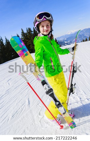 Ski, winter fun - lovely skier girl enjoying ski vacation