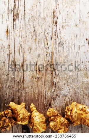 Fresh organic topinambur on wooden background, Jerusalem artichoke