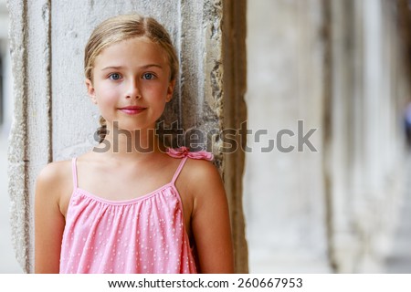 Happy beautiful young girl in summer dress posing joyful and cheerful smiling in Venice, Italy.