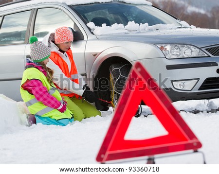 Similar – Image, Stock Photo Woman putting security snow chain in tire wheel of car