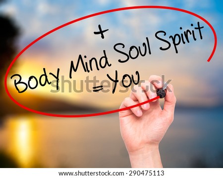 Man Hand writing Body + Mind + Soul + Spirit = You with black marker on visual screen. Isolated on nature. Life, technology, internet concept. Stock Image