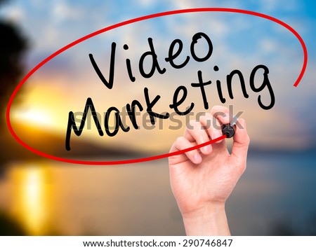 Man Hand writing Video Marketing with black marker on visual screen. Isolated on sunset. Business, technology, internet concept. Stock Image