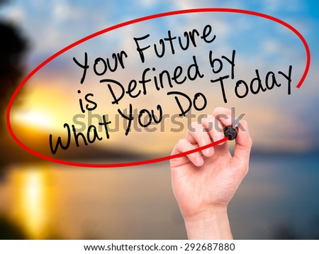 Man Hand writing Your Future is Defined by What You Do Today with black marker on visual screen. Isolated on nature. Business, technology, internet concept. Stock Image
