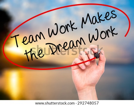 Man Hand writing Team Work Makes the Dream Work with black marker on visual screen. Isolated on nature. Business, technology, internet concept. Stock Image