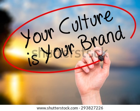Man Hand writing Your Culture is Your Brand with black marker on visual screen. Isolated on nature. Business, technology, internet concept. Stock Photo
