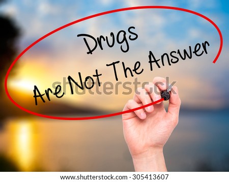 Man Hand writing Drugs Are Not The Answer with black marker on visual screen. Isolated on nature. Business, technology, internet concept. Stock Photo