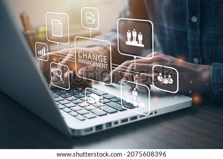 Businessman using a computer to document Change management in organization and business concept with consultant presenting icons of strategy. Organizational transition and transformation Stockfoto © 