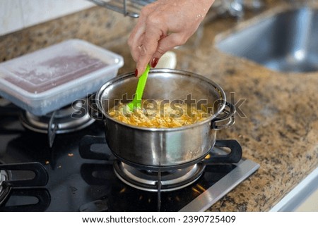 Similar – Image, Stock Photo Pan with rice and beans decorated with chopped green chilies and served on a wooden table