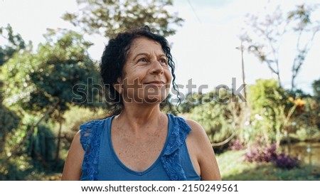 Similar – Image, Stock Photo Lovely curly woman with combed hair, keeps hand in pocket