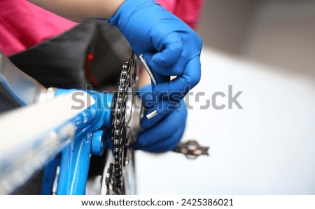 Similar – Image, Stock Photo Repairman fixing bicycle wheel in workshop