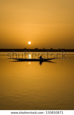 Fishermen in a canoe sunset