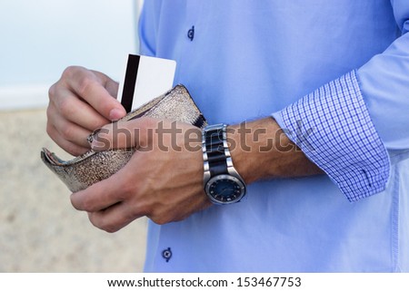 Businessman takes out a credit card from the wallet