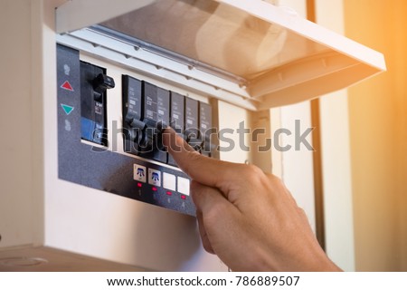 The electrician on hand open circuit breaker board. Selective focus. Foto d'archivio © 