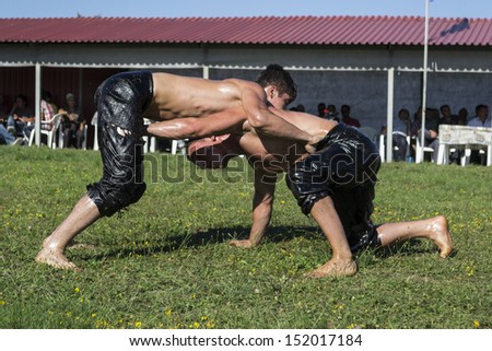 HILIA EVROS, GREECE - AUGUST 18:Unidentified wrestlers in the  Annual Oil Wrestling Event in HILIA-EVROS. Pehlivan aims control his opponent on August 18, 2013 in Hilia Evros, Greece